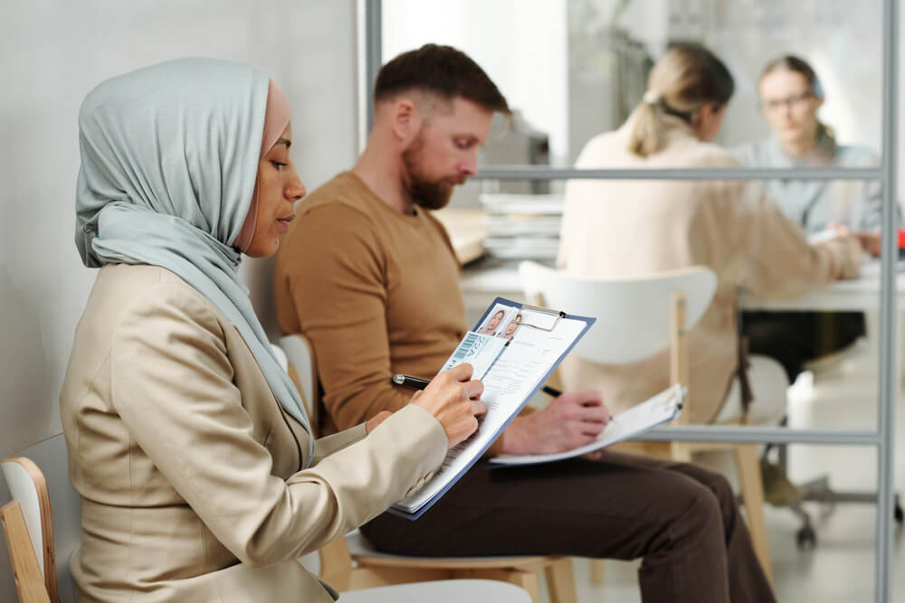 Lady in hijab filling out paperwork