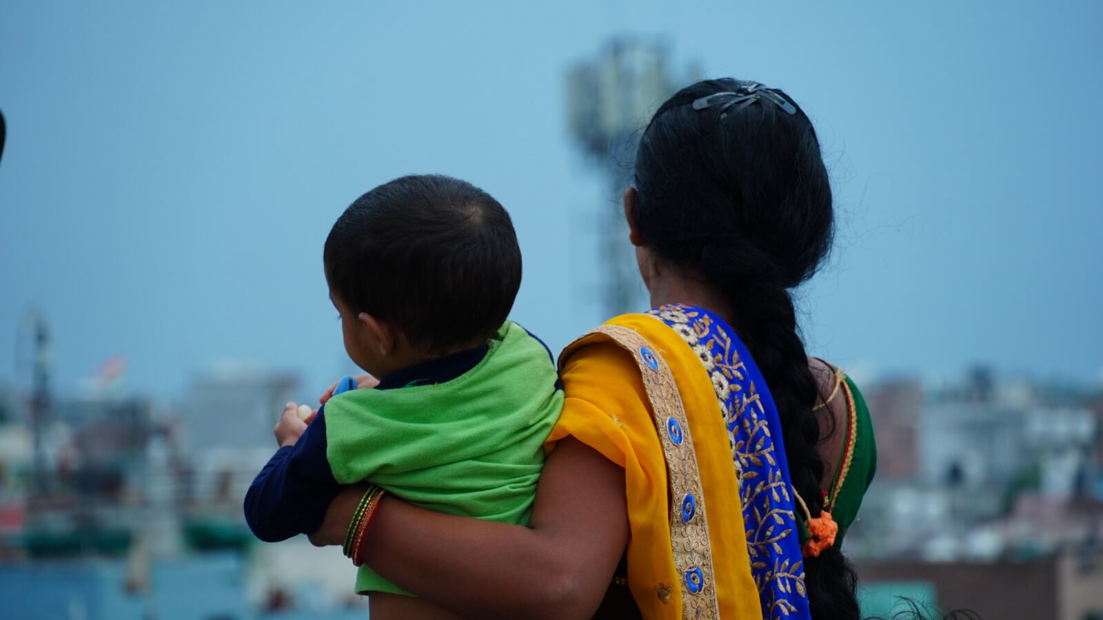 Woman wearing Indian saree holding her son